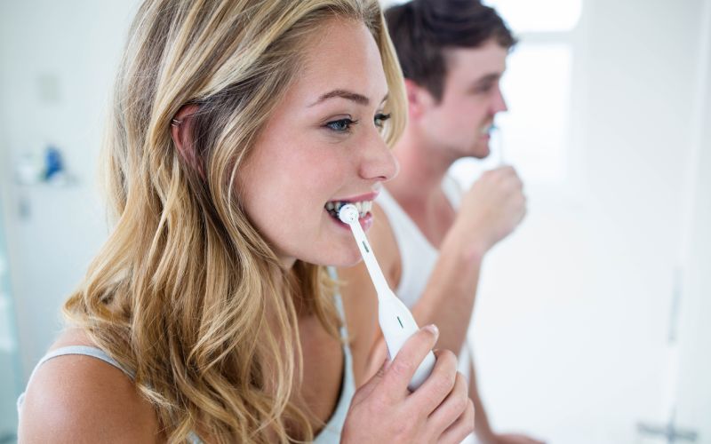 couple brushing teeth at home